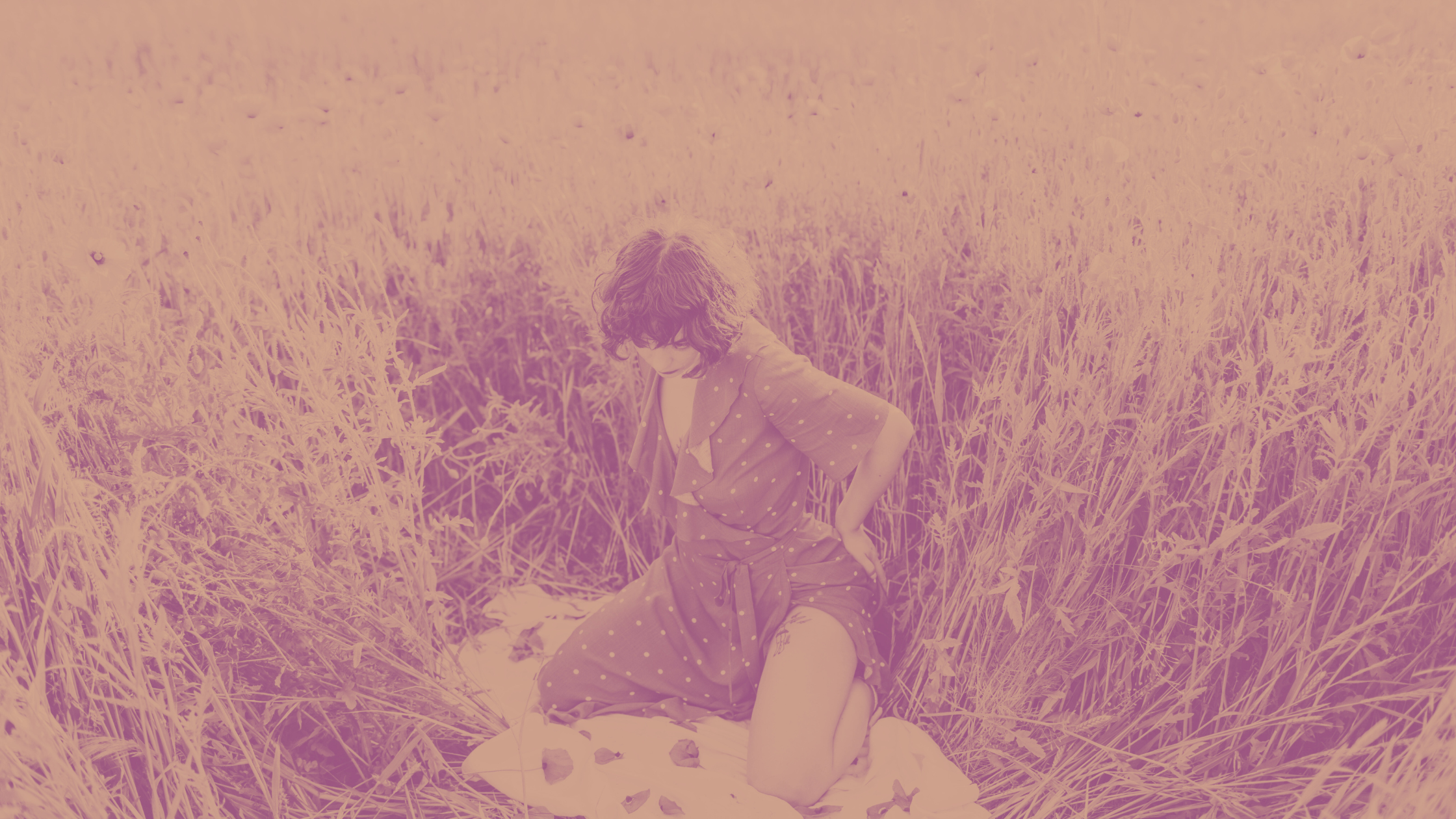 woman in a grass field wearing sustainable clothes